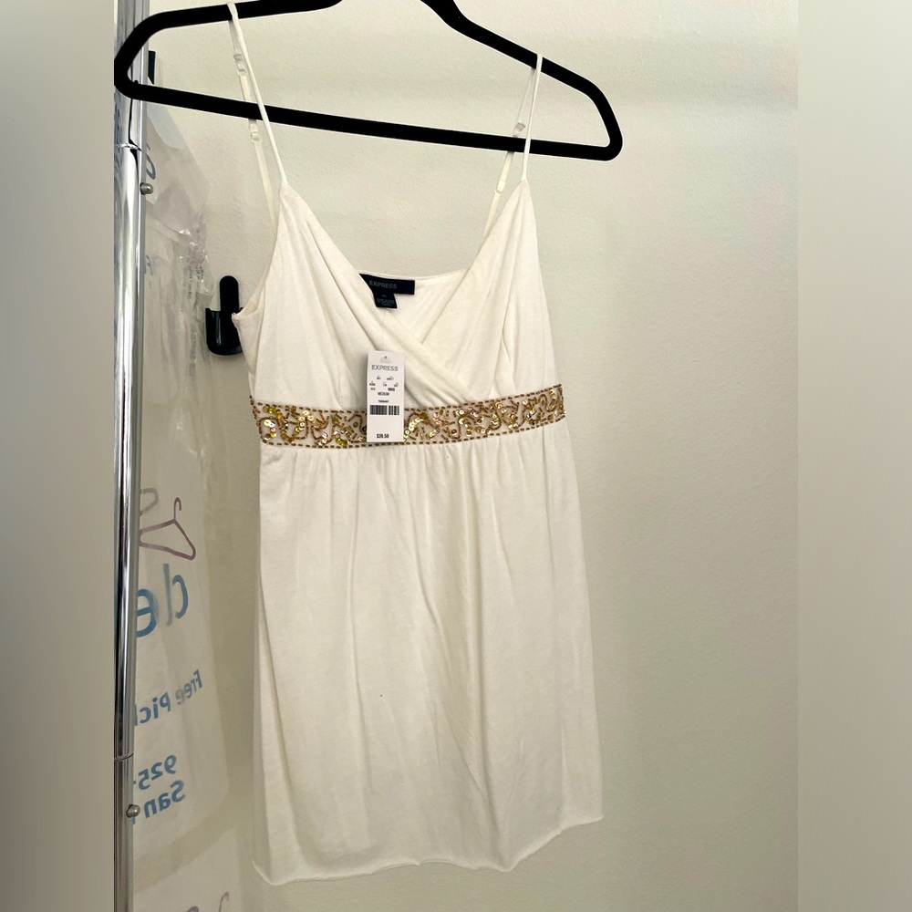 NEW. Medium spaghetti strap Express tank top with gem embellishments in front.